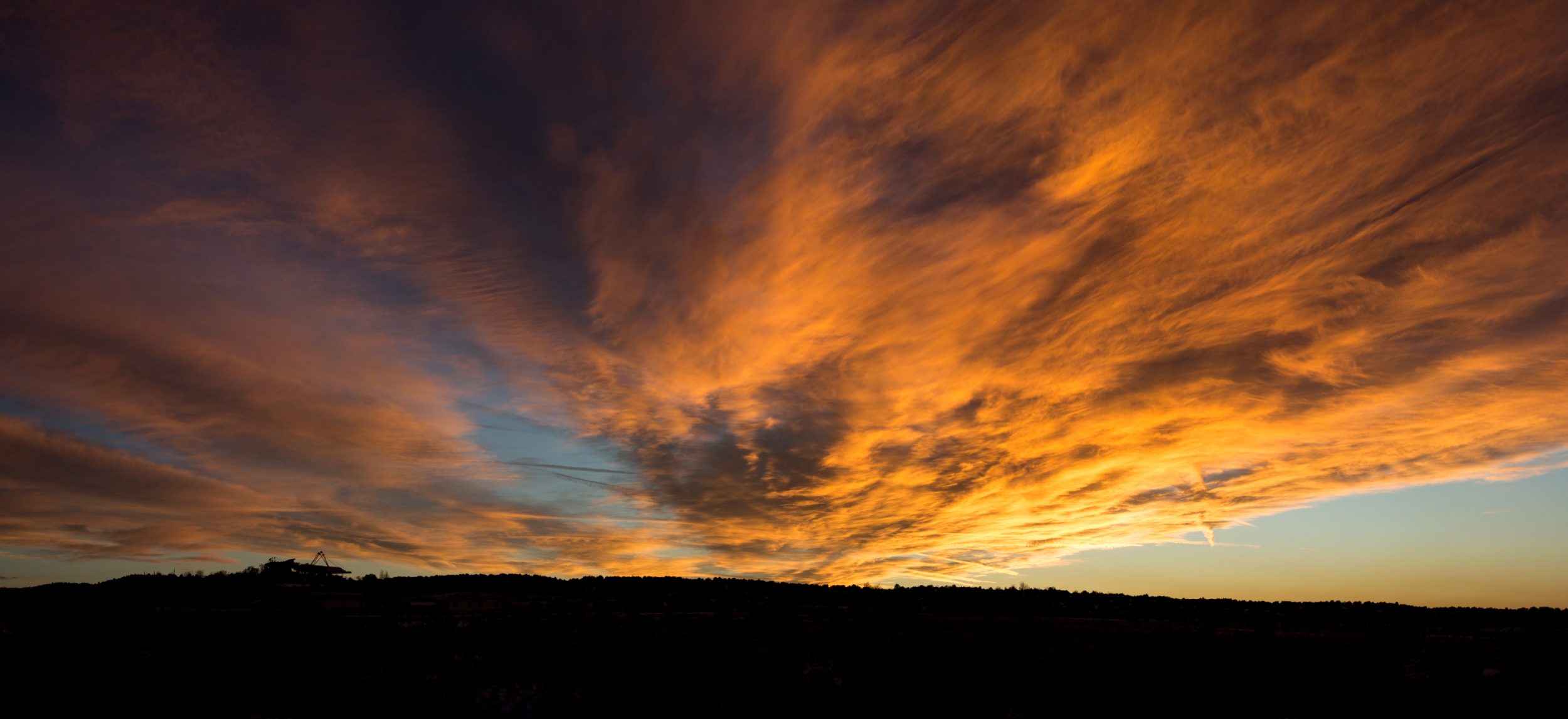 Massive sunset with theatre in distance