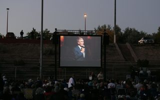 Richard Gaddes on the simulcast screen at Fort Marcy Park, Santa Fe, NM