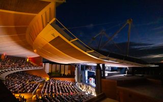 Patrons observe a production in The Crosby Theatre at the Santa Fe Opera